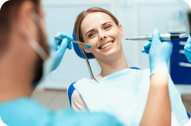 Lady undergoing Teeth whitening in Dental Clinic