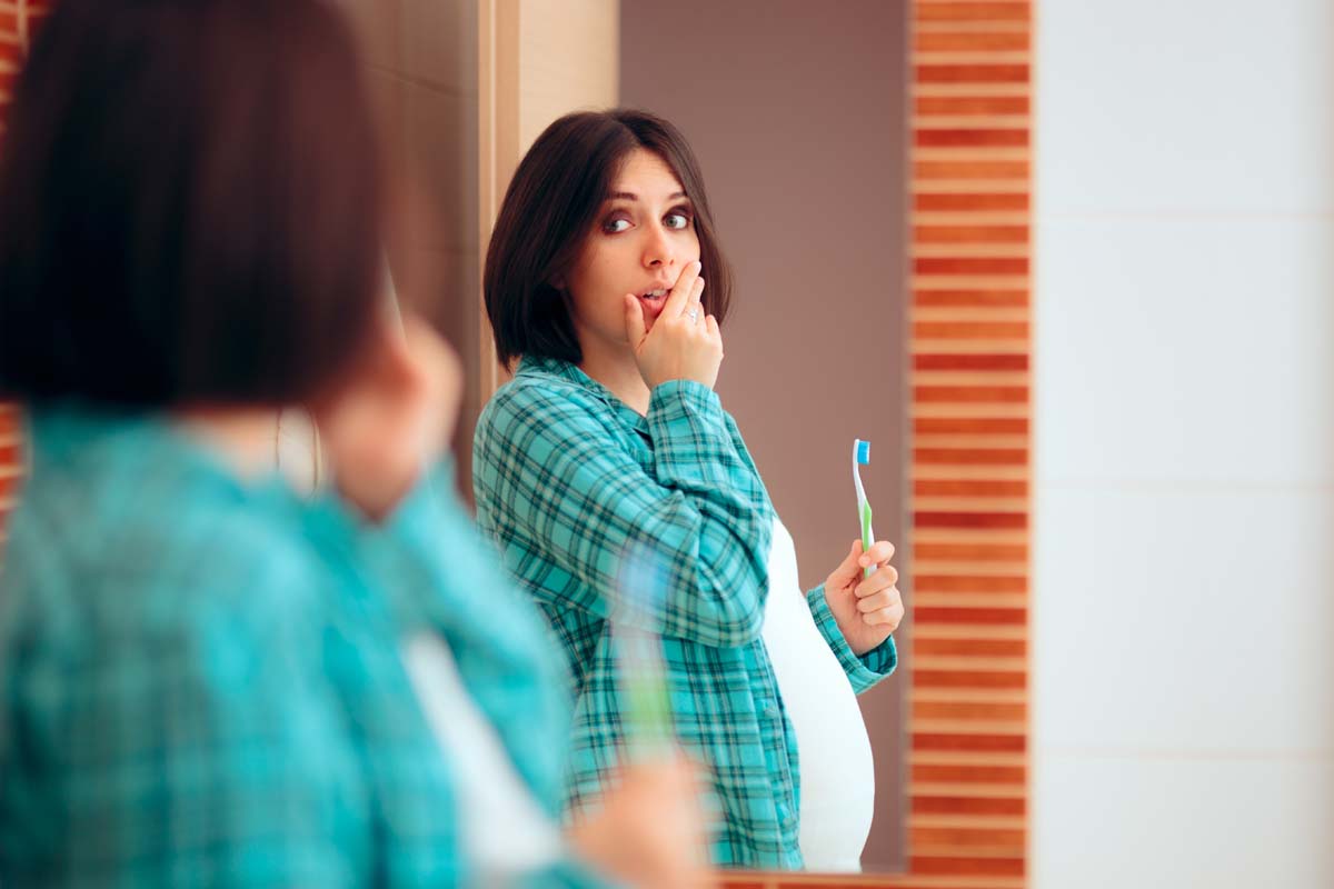 Pregnant Woman with Tooth Ache and Sore Gums with pregnancy difficulties in her last trimester